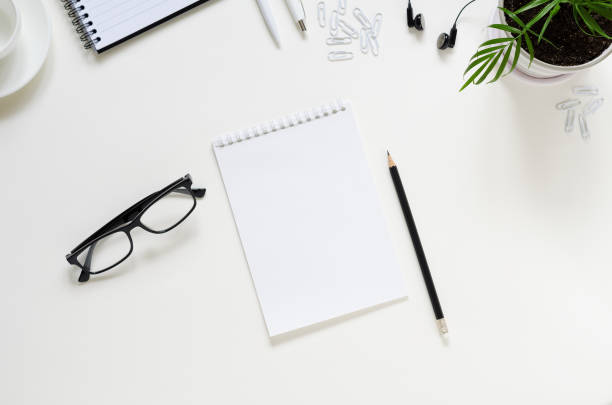 istock Workspace with pen, paper, coffee cup and office supplies. 1264436245