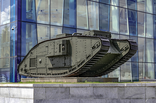 Kharkiv, Ukraine - July 20, 2020: Mark V Composite tank on Constitution Square against the background of the blue glass wall of the Kharkiv Historical Museum. Monument from the First World War