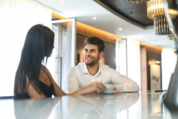 istock Young couple talking at a bar counter 1264439537