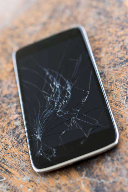 istock Close up of broken mobile phone with cracked display 1264439690