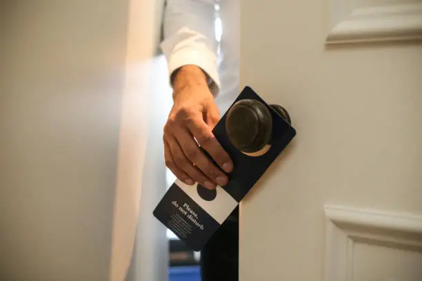 Photo of Man putting a Do not disturb sign