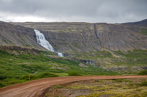 Waterfall and a steep mountain in a remote part of Iceland