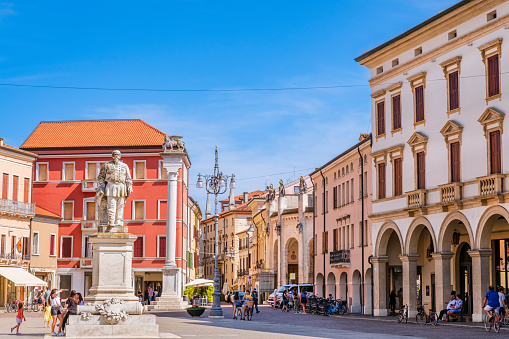 Vittorio Emanuele II Square is the most important square of Rovigo, a city in Veneto, northeast Italy. In the square stands the monument to Vittorio Emanuele II, the first king of Italy. People strolling.