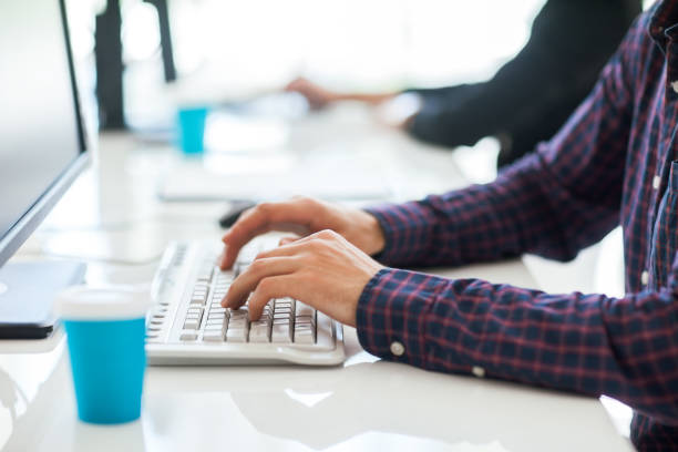 istock Close up of male hands typing on computer keyboard 1264446117
