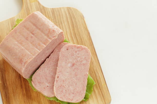 sliced luncheon meat on wooden board