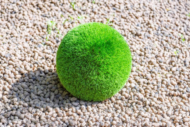 Plastic green ball made of artificial grass as an element of garden decoration
