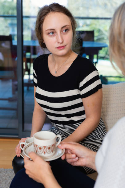 istock Two women talking at home 1264452363