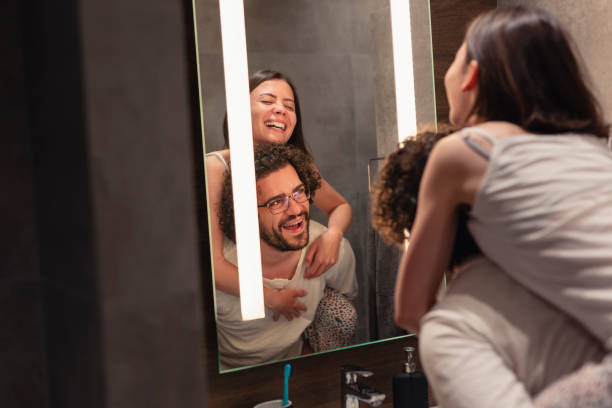 istock Couple having fun in front of bathroom mirror 1264452399