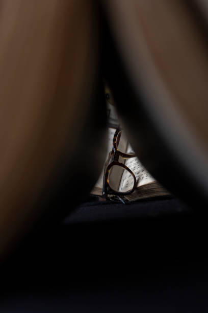 istock Vintage pair of glasses viewed through the book 1264452836