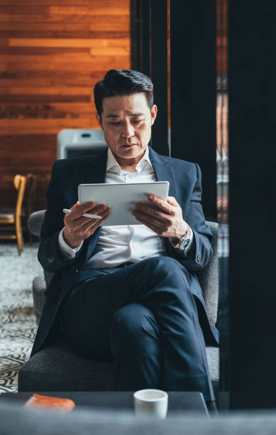 istock Handsome business man looking at tablet stock photo 1264453904