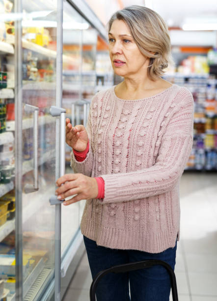 istock Mature woman choosing dairy products 1264453922