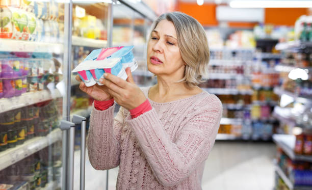 istock Mature woman choosing dairy products 1264453923