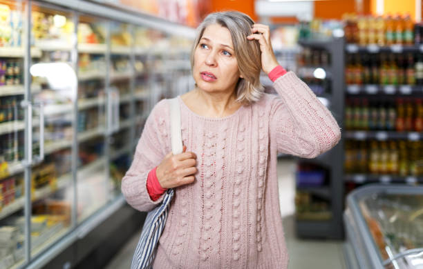 istock Pensive female shopping at store 1264453927