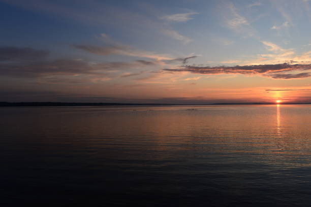 istock Sunbeam at sunset on the lake water surface 1264454597