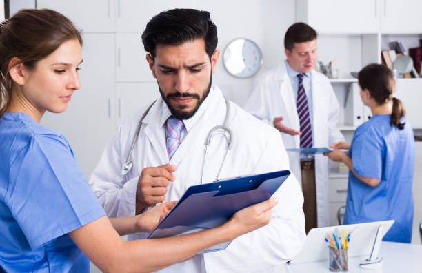 istock Doctor with younger female colleague 1264456028