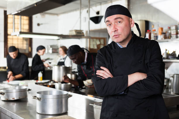 istock Confident male chef posing at restaurant kitchen 1264457425