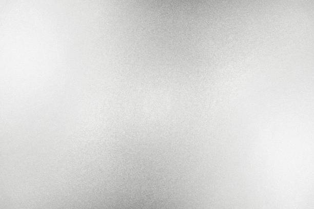istock Glowing white silver glitter paper wall with copy space, abstract texture background 1264459004