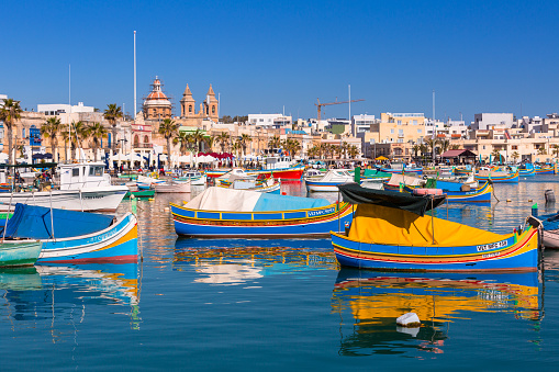 Sliema, Malta - January 10, 2020: Traditional fishing boats in the Mediterranean Village of Marsaxlokk, Malta