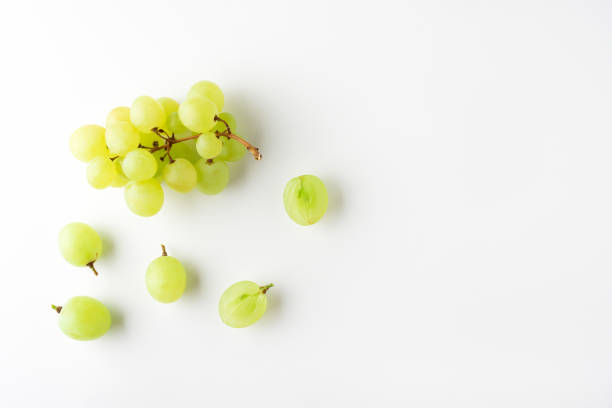 istock Green grape without leaves on white background. Flat lay. Summer food concept. 1264465496
