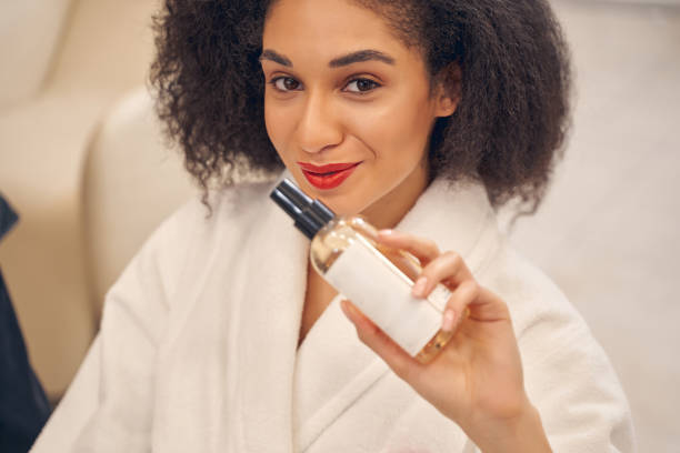istock Charming lady with cosmetic product in hand 1264469337