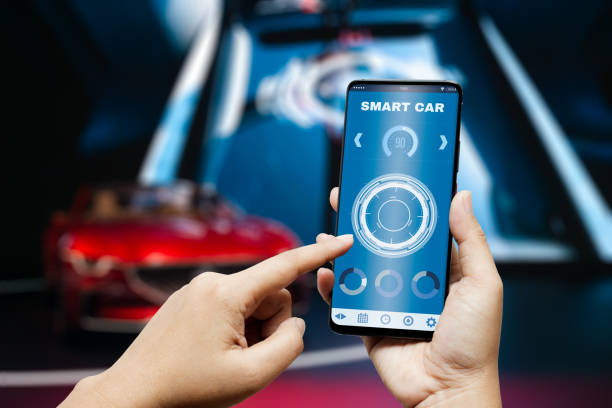istock Smart car appliction background concept. Hand holding smart phone and application dashboard with blurred sport car as background. Internet of things IOT in smartcar concept. 1264469469