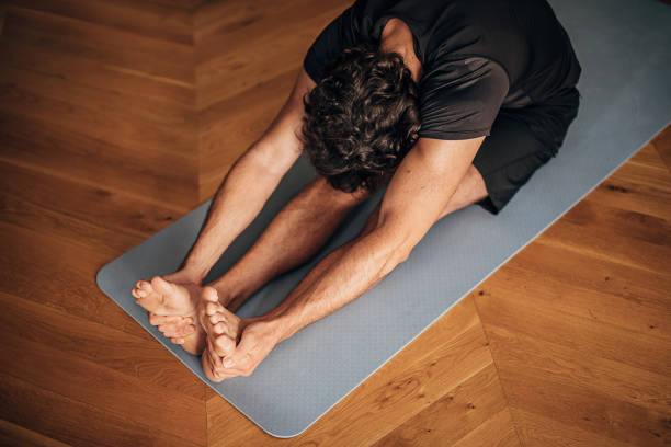 istock One man doing yoga on exercise mat at home 1264471685