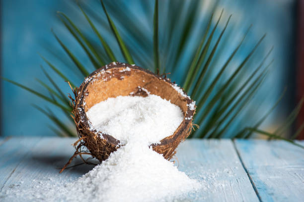 istock Grated coconut powder falling out of a shell 1264473613
