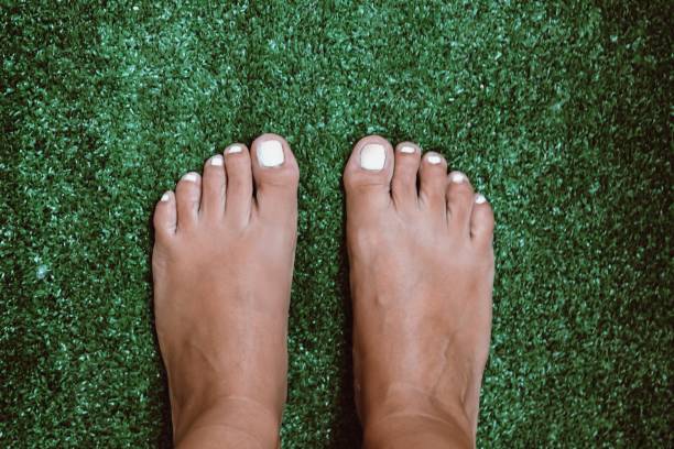 istock bare feet on the green grass 1264475724