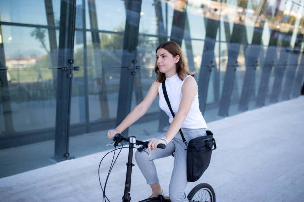istock Businesswoman with her folding bike going to work 1264477816