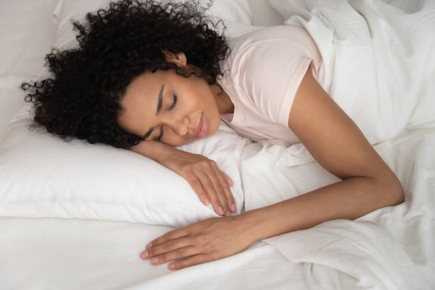 istock Peaceful beautiful African American woman sleeping in comfortable bed 1264479209