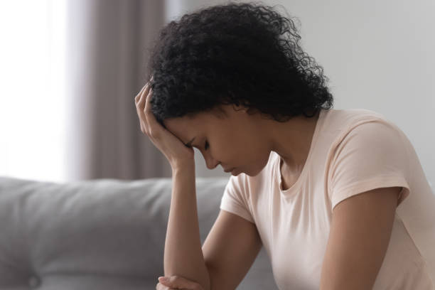 istock Unhappy exhausted African American woman thinking about problems close up 1264479266