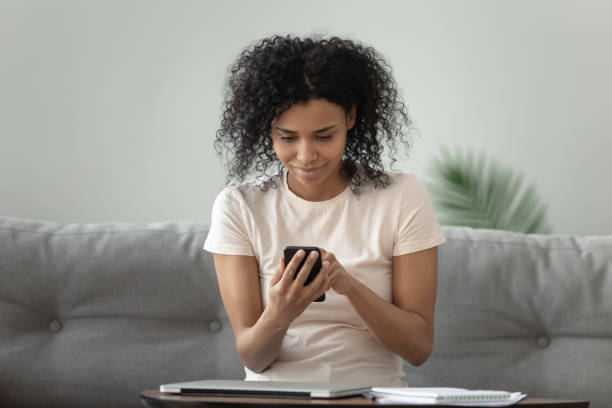 istock Beautiful African American woman using phone, browsing mobile apps 1264479310
