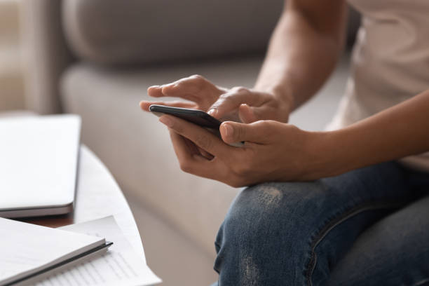 istock Close up African American woman holding cellphone, using apps 1264479313