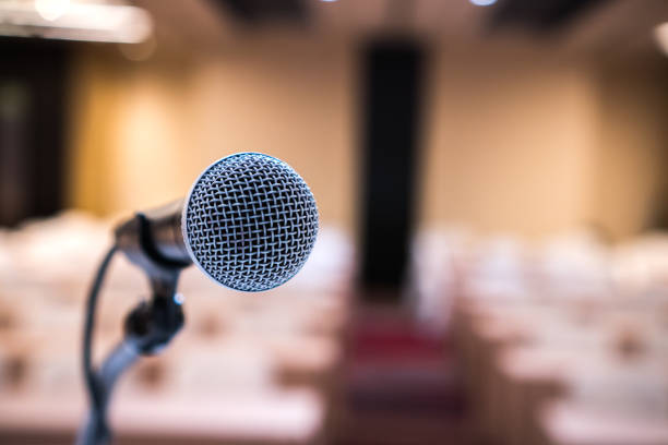 istock Microphones for speech or speaking in seminar Conference room, talking for lecture to audience university, Event light convention hall Background. Business Talk Presentation concept 1264486443