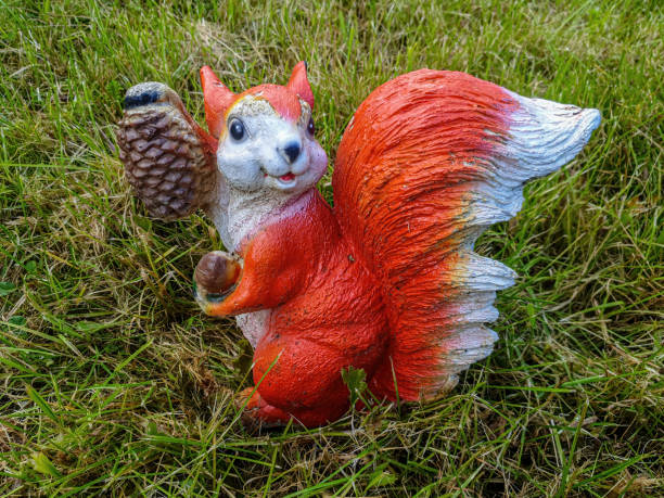 istock Decorative garden decoration in the form of a squirrel. 1264486476