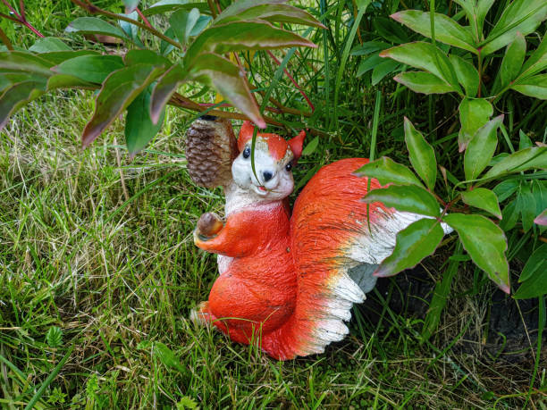 istock Decorative garden decoration in the form of a squirrel. 1264486606