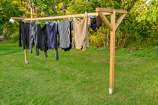 clothes hanging to dry on home made drying rack in a Swedish garden