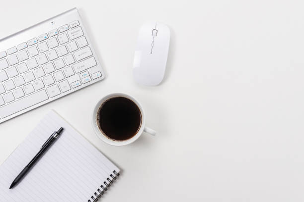 istock White office desk table with blank notebook, computer keyboard and other office supplies. Top view with copy space. 1264496829