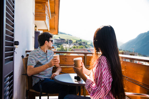 istock couple relaxing on balcony in dolomiti 1264500881