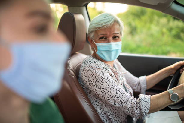 istock Senior woman enjoying company while driving 1264500963