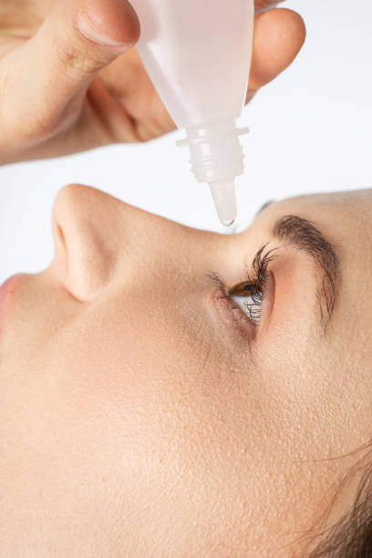 istock Young woman with brown eyes using eye drops 1264505525
