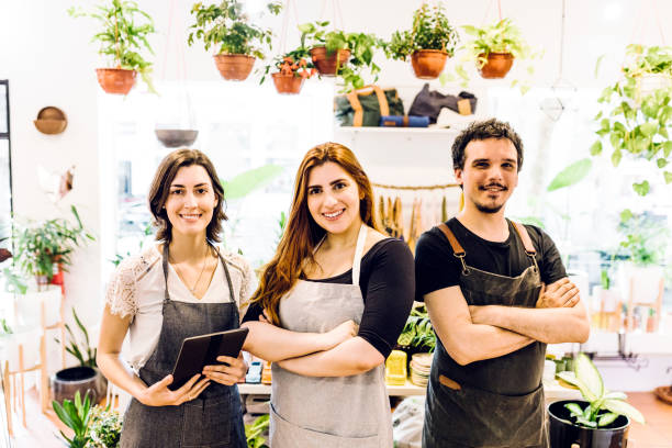 istock Shop Owner standing with employees 1264508673