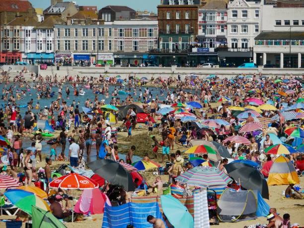 Crowded Beach on the Hottest Day of the Year Margate Kent, UK - 7 August 2020: Visitors cool off at Margate's crowded Main Sands on the hottest day of the year. thanet photos stock pictures, royalty-free photos & images