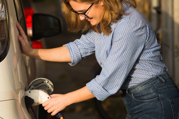 istock Woman charging electric car 1264514392