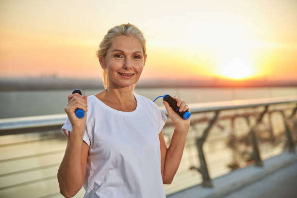 istock Smiling fit mature pretty lady looking ahead 1264515878