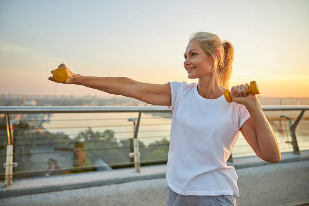 istock Woman performing a strength training exercise outdoors 1264515945
