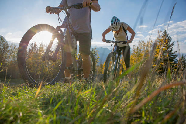 istock Mountain biker rides along grassy path, in autumn 1264516736