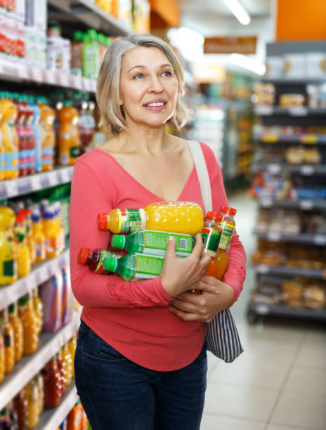 istock woman choosing and buying refreshing fruit drinks 1264524001