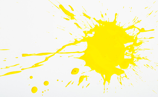 Spilled yellow paint spots on paper, colorfull artistic image on white background
