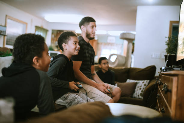 istock Boys Play Video Games With Their Dad 1264525775